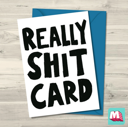 Card with 'REALLY SHIT CARD' text on a wooden surface